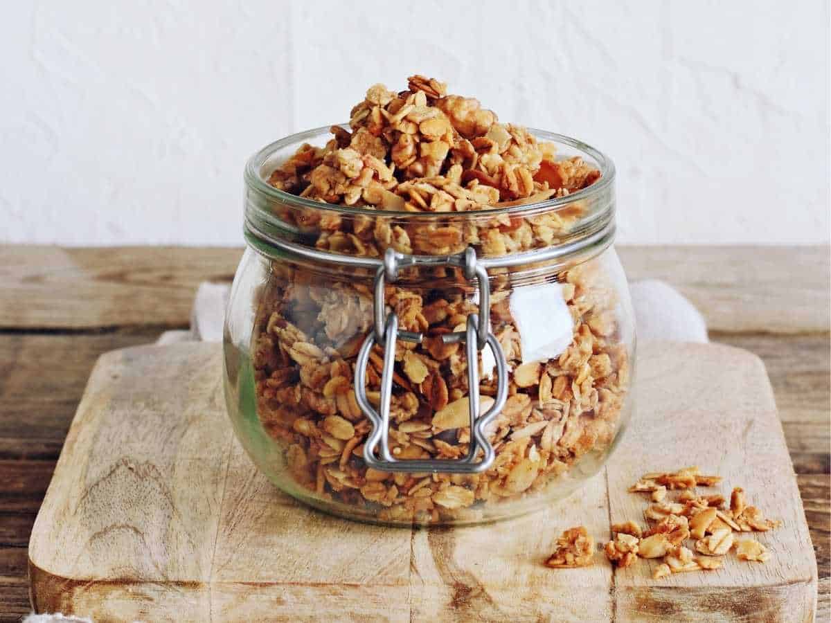 Homemade rolled oats granola in a glass jar.