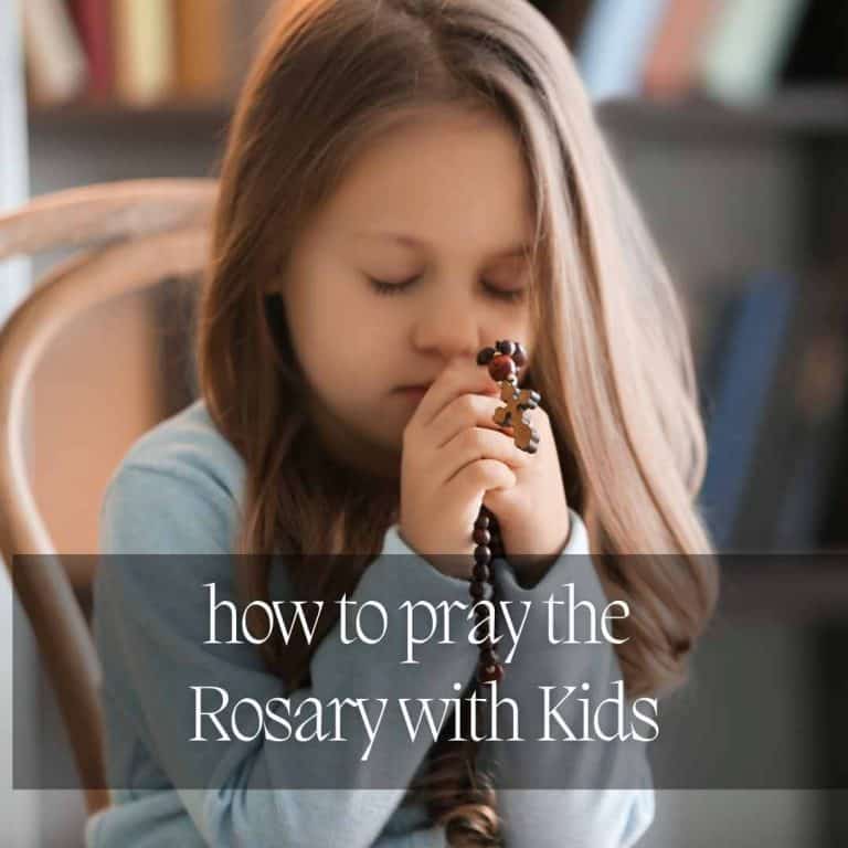 a girl fo about 5 is bowing her head to pray the wooden rosary beads she holds