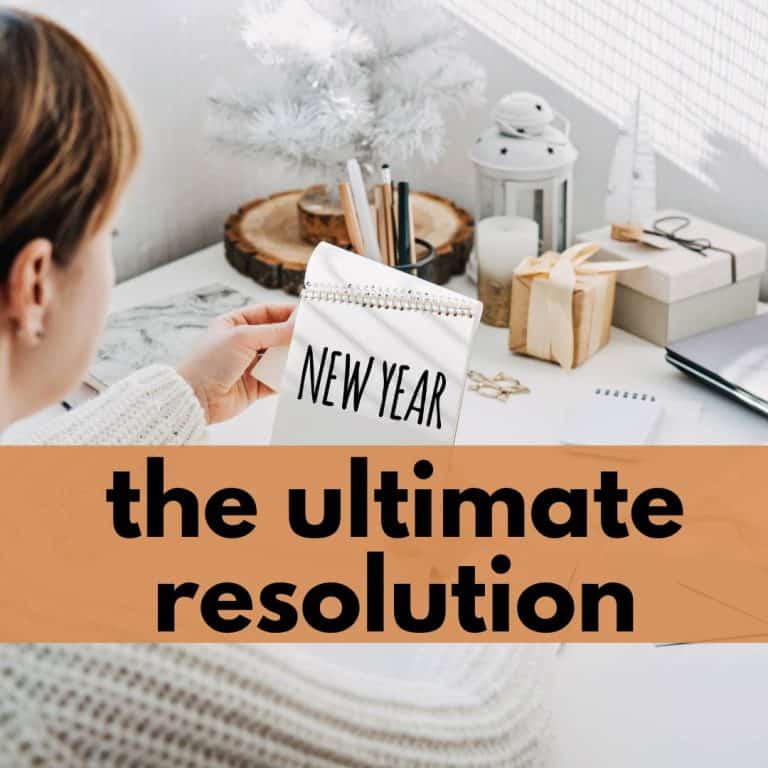 woman at a desk looking at a notebook that reads new year